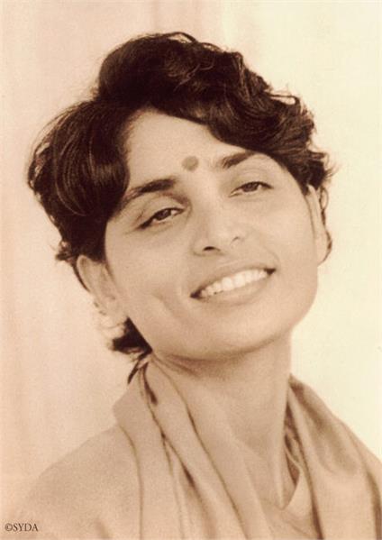 Close up, black and white photo of Gurumayi smiling