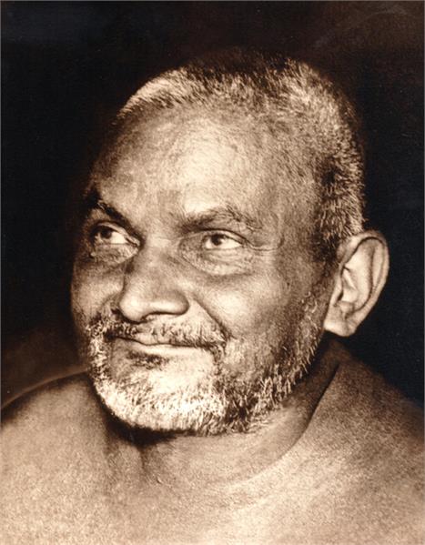 Close up photo of Nityananda slightly smiling