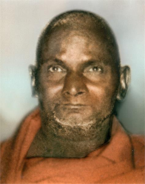 Close up, colour photo of Nityananda in orange robes